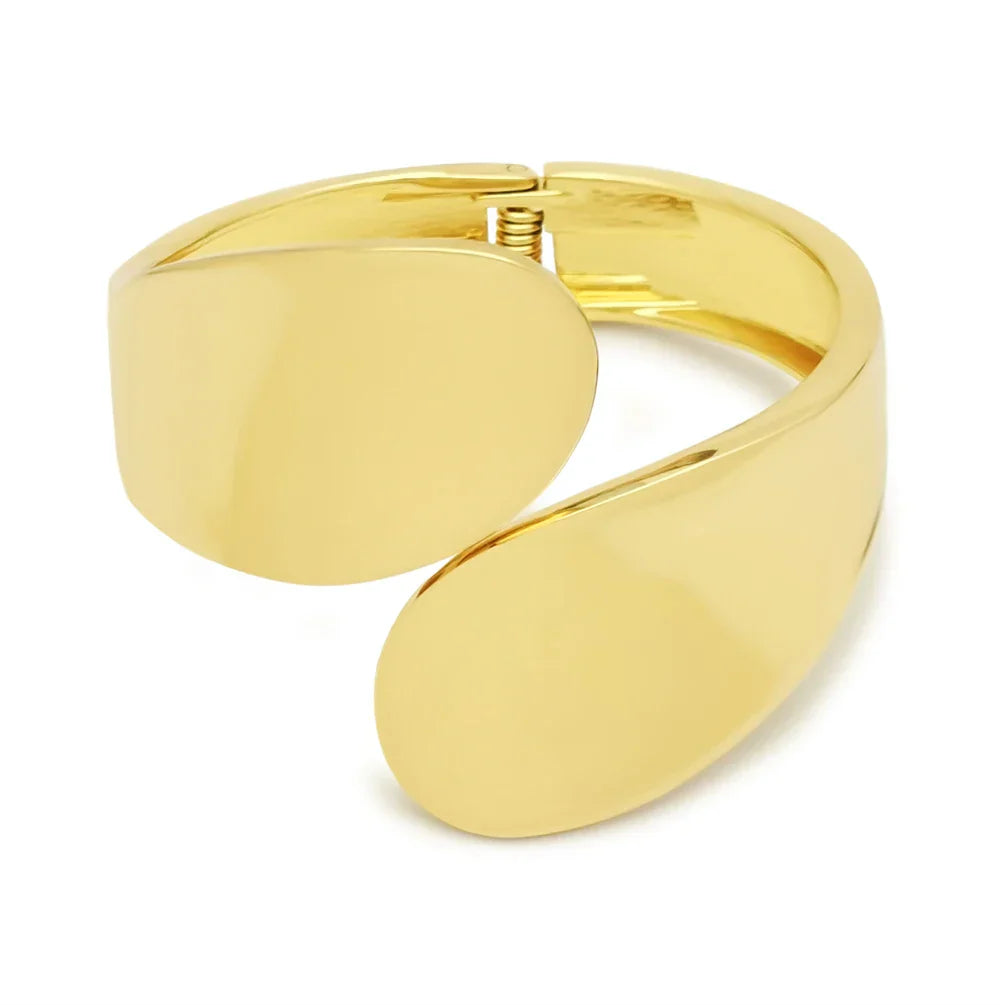 Gold wide cuff bracelet with a smooth, curved design. A bold and elegant accessory for special occasions.