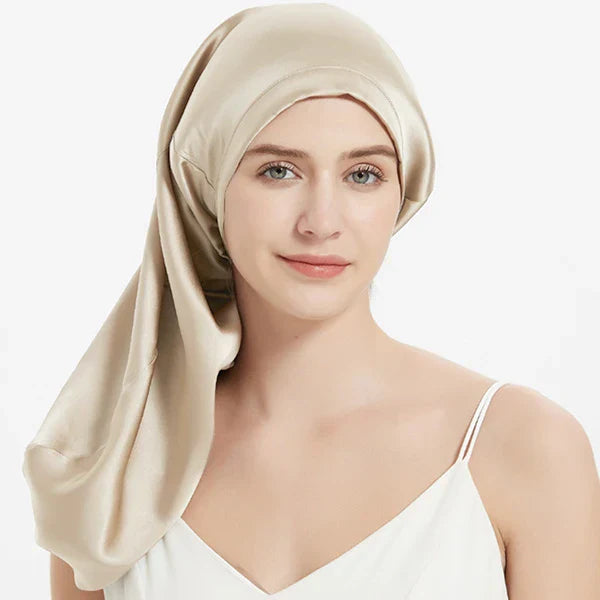 Light gold Mulberry Silk Sleep Bonnet for long hair, modeled by woman. Frizz-free silk headwrap for protective styling overnight.
