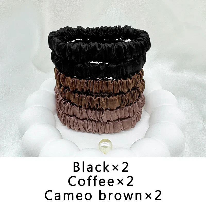 Six-piece silk elastic hair band set in black, coffee, and cameo brown. Frizz-free, snag-free styling for natural hair.