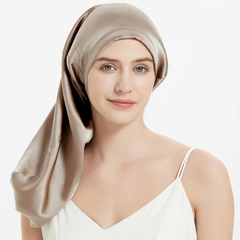 Champagne Mulberry Silk Sleep Bonnet for long hair, modeled by woman. Smooth silk headwrap for frizz control and adjustable fit.