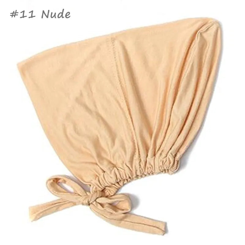 Nude-colored adjustable headwrap with a soft fabric and tie-back design, perfect for a comfortable and elegant look.