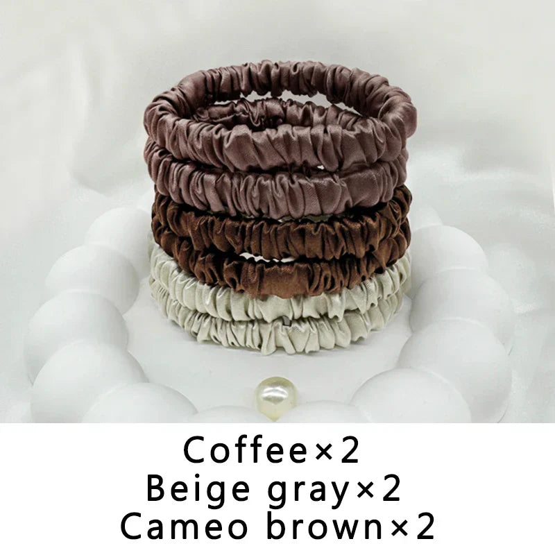 Six-piece set of mulberry silk elastic hair bands in coffee, beige gray, and cameo brown. Frizz-free hold for natural hair and locs.