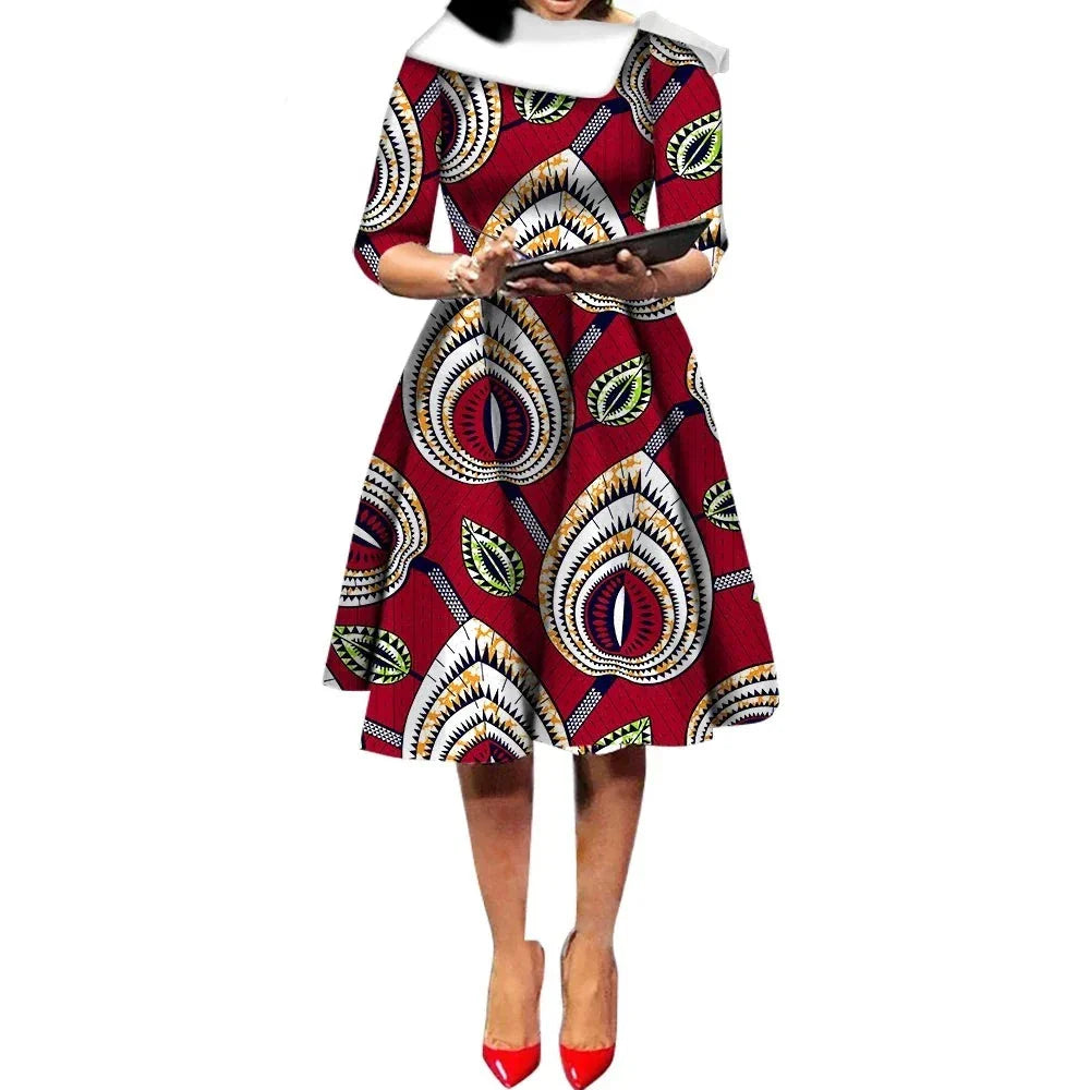 African Ankara Wax Print Midi Dress in deep red with intricate teardrop patterns, featuring a fitted waist and flared skirt.