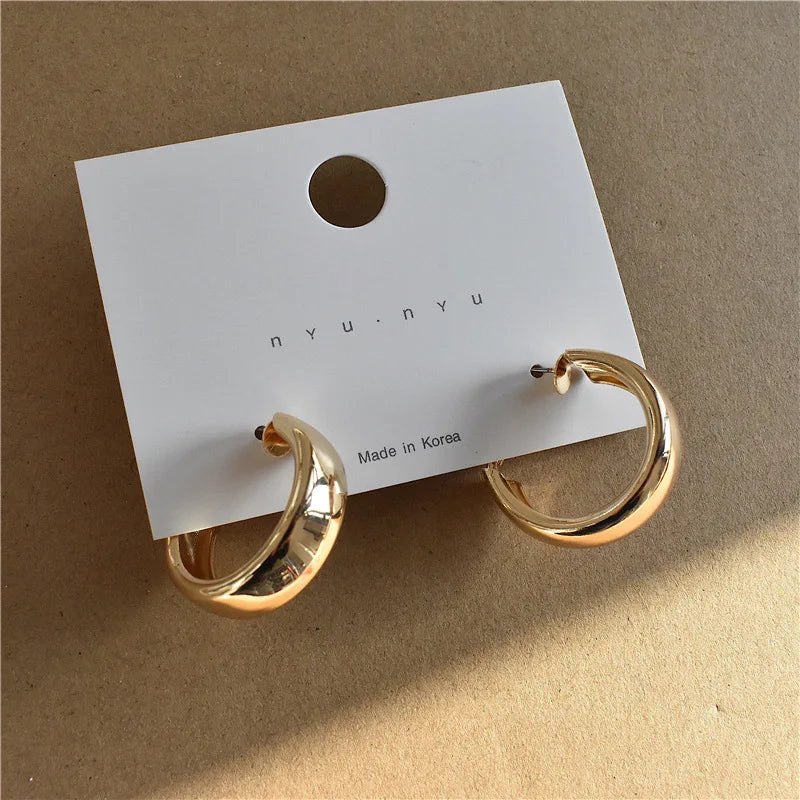 Gold-tone chunky hoop earrings displayed on a branded card. Elegant and stylish modern vintage earrings for women.