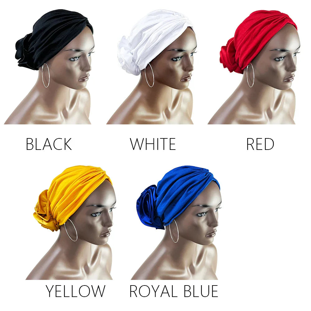 Floral stretch bandana head wrap available in black, white, red, yellow, and royal blue. Elegant fabric rose detail for a stylish look.