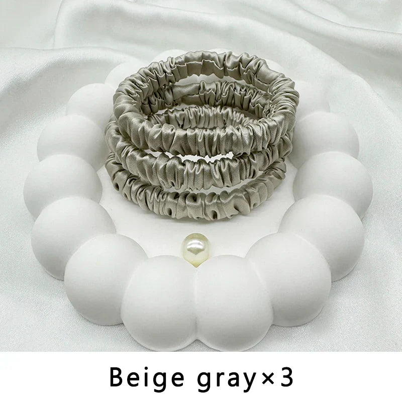 Three beige gray mulberry silk elastic hair bands. Frizz-free, gentle ponytail holders for natural and textured hair.