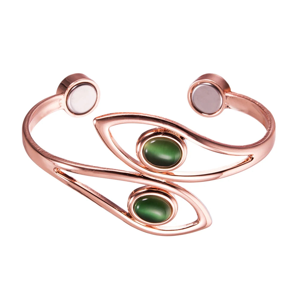 A rose gold cuff bracelet featuring two oval green stone inlays and two round pale pink stone inlays on a solid white background.