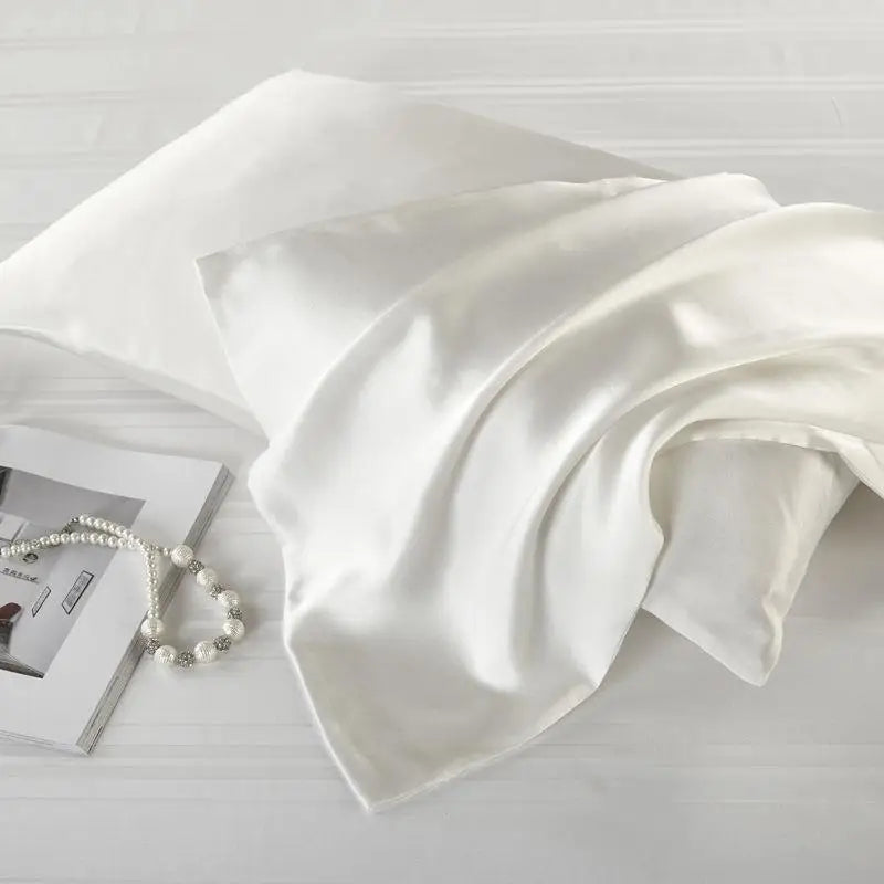 Elegant white natural mulberry silk pillowcase for locs. Ultra-soft, breathable, and designed to protect hair from frizz and breakage.