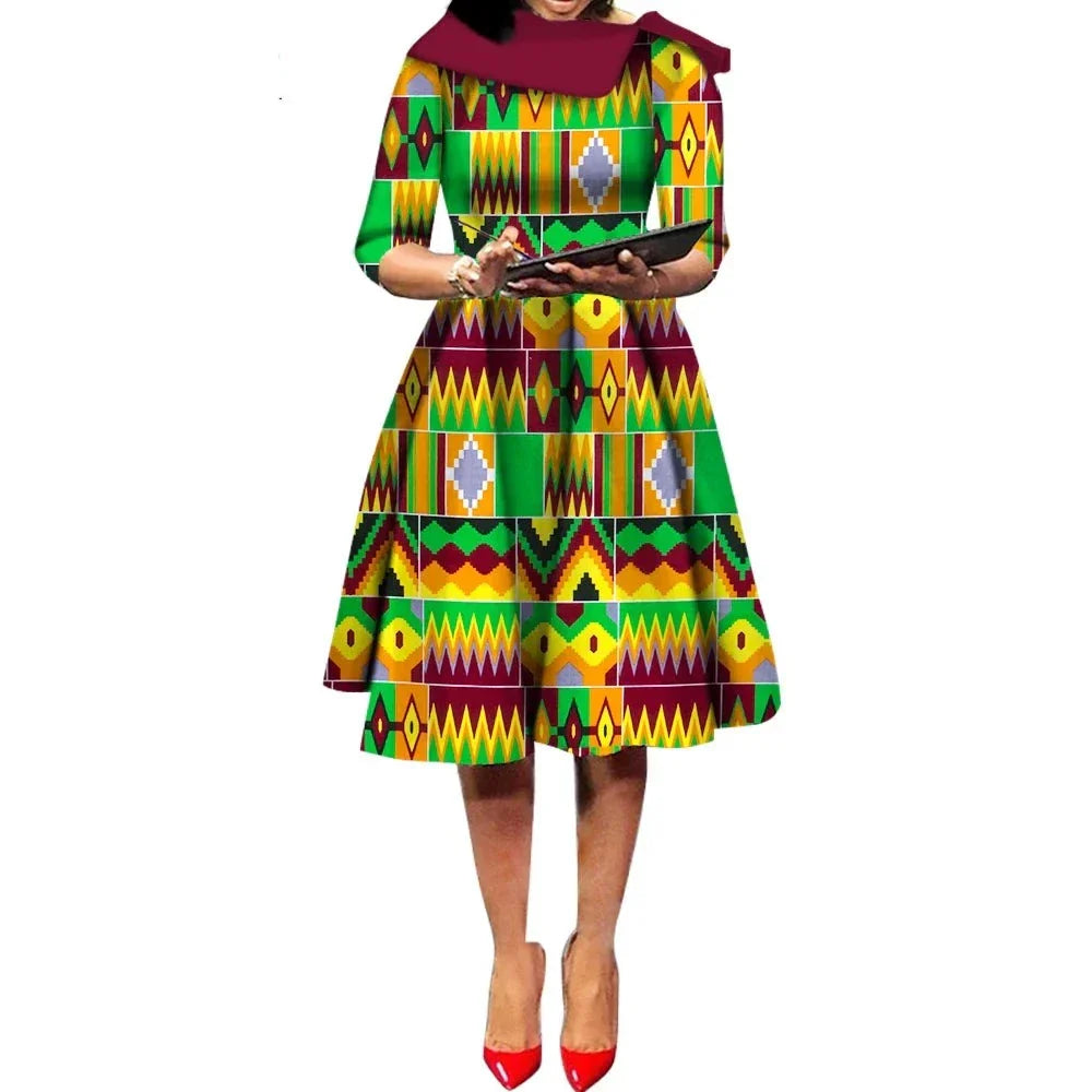 African Ankara Wax Print Midi Dress with a green and yellow geometric pattern, inspired by traditional African designs.