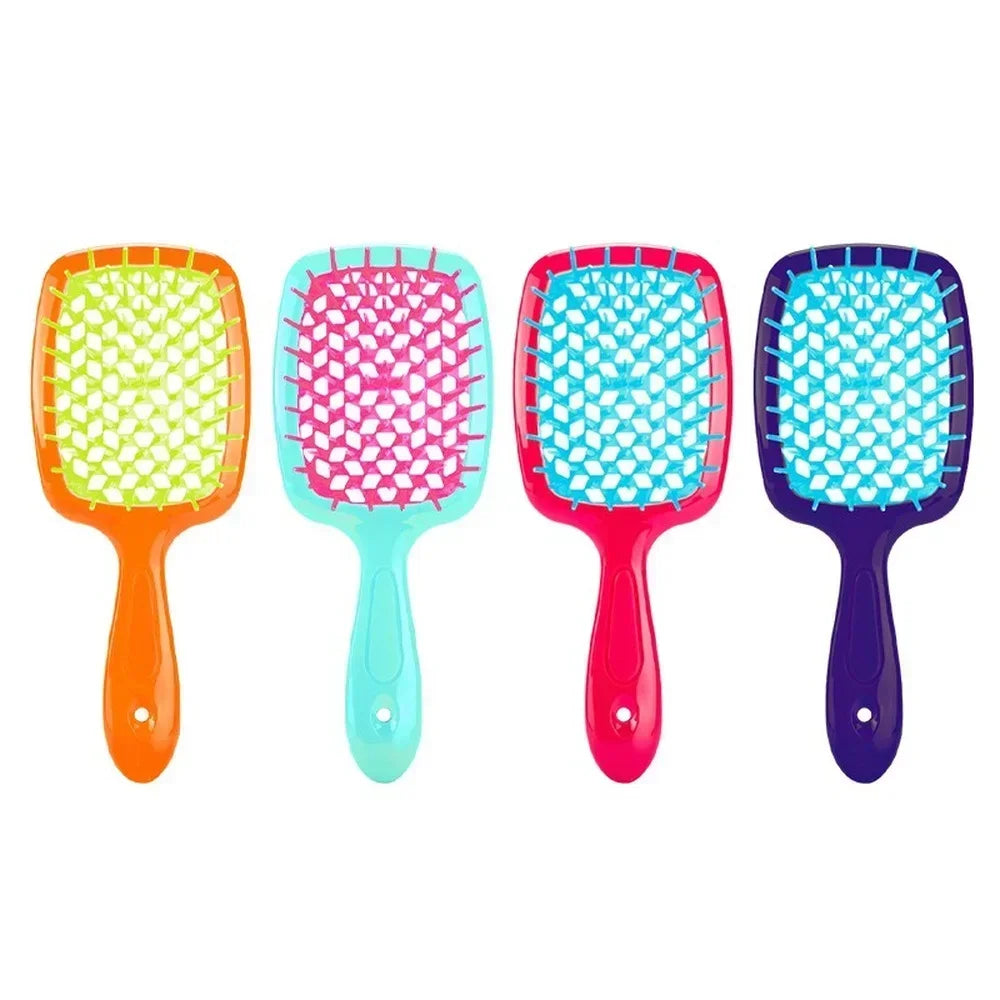 Turquoise detangling brush with pink bristles. Perfect for curly and 4C hair, reducing breakage and ensuring smooth styling.