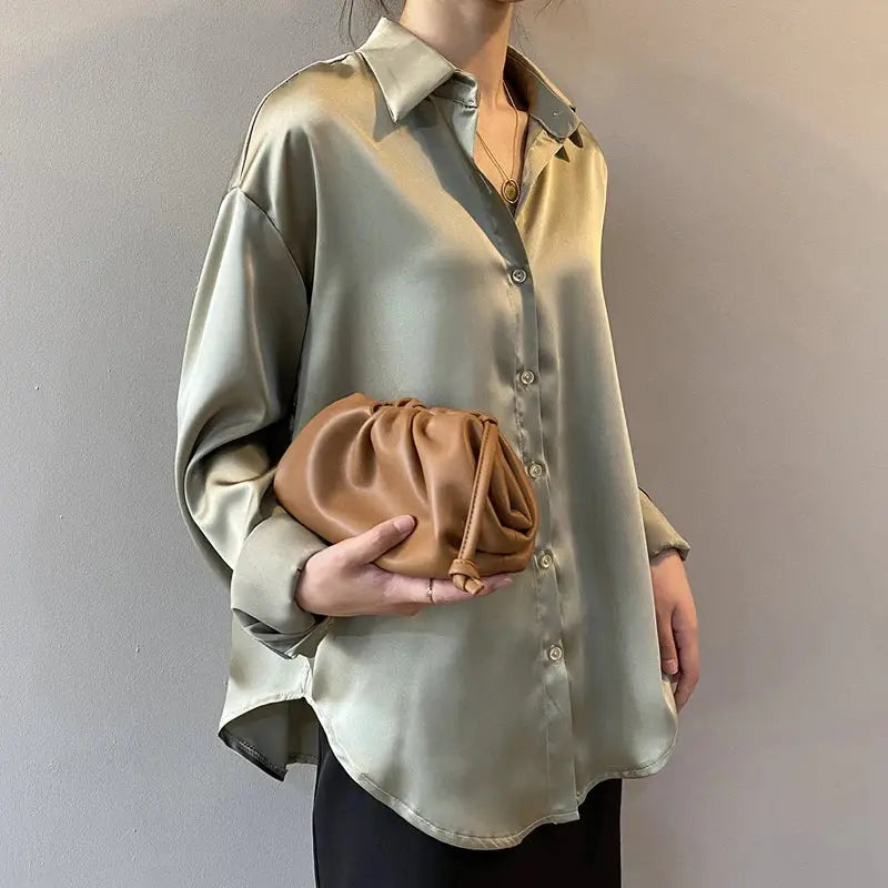 Luxurious satin blouse in a neutral tone with a relaxed fit and button-down front. A versatile wardrobe essential for any occasion.
