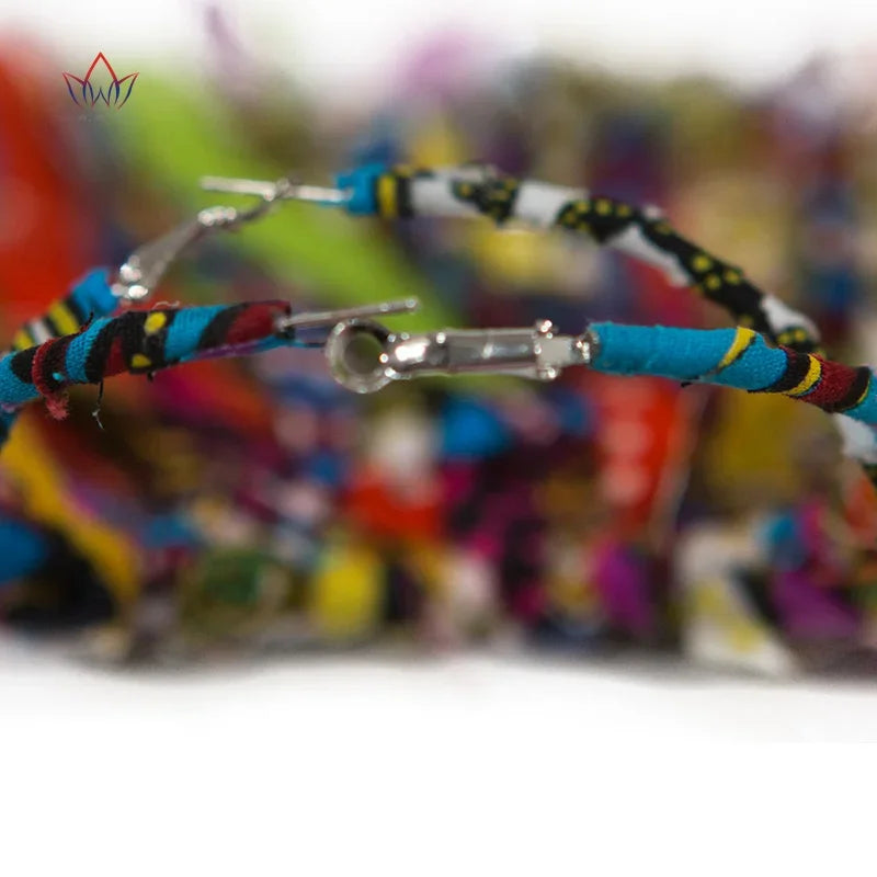 Handmade African fabric earrings with tassels in bright, multicolor patterns. Large hoop earrings with cascading fabric strips for a bold look.