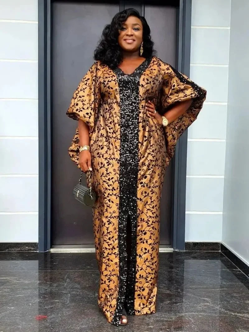 Chic abaya maxi dress with flare sleeves in brown and black floral patterns, adorned with a sequin front panel and a front slit for elegance.