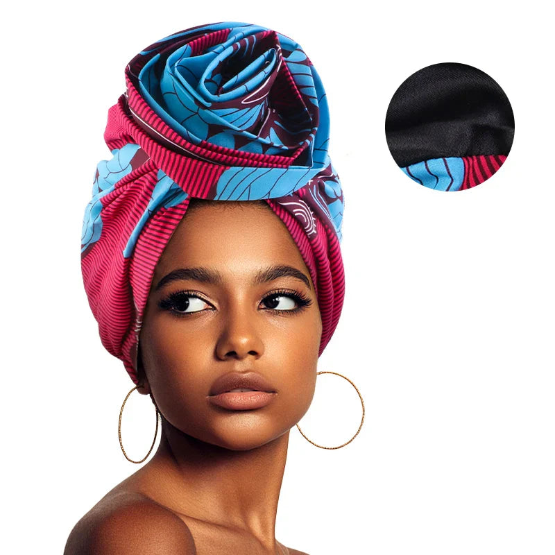 Pink and blue Afrocentric Melody Headwrap with satin lining, offering a bold and elegant look. Pre-tied design makes it easy to wear for any occasion.