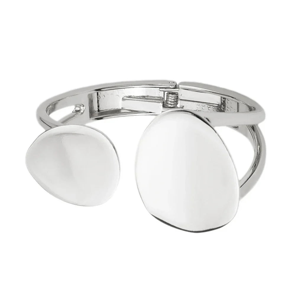 Silver open cuff bracelet with a minimalist, organic shape. A stylish and elegant accessory for special occasions.