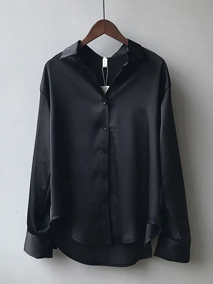 White satin blouse with a relaxed fit and button-down front. A timeless and elegant choice for professional and casual outfits.