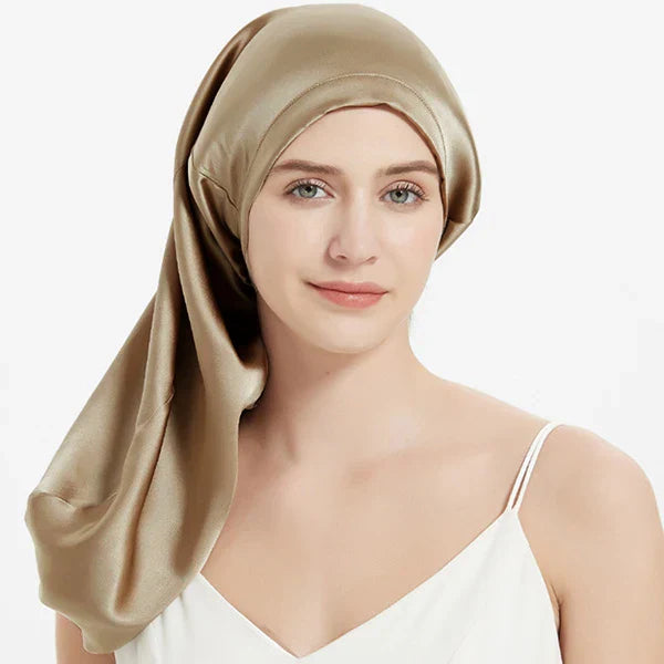 Golden Mulberry Silk Sleep Bonnet for long hair, worn by woman. Luxurious silk headwrap for frizz-free mornings and protective styling.