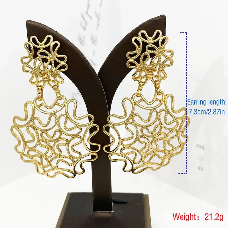 Gold-plated starry earrings with intricate detailing displayed on a stand, measuring 7.3cm in length and weighing 21.2g for an elegant touch.