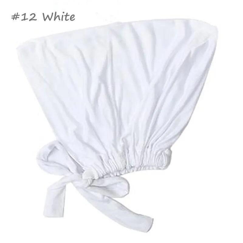 White adjustable headwrap with a gathered elastic and tie-back closure, designed for a secure and stylish fit.