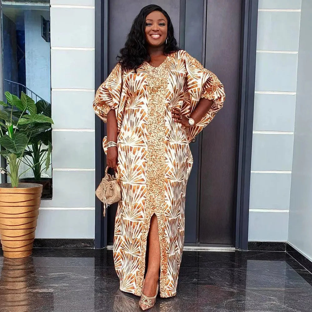 Woman wearing a beige and gold patterned abaya maxi dress with flare sleeves, styled with a sequin front panel and a front slit for elegance.
