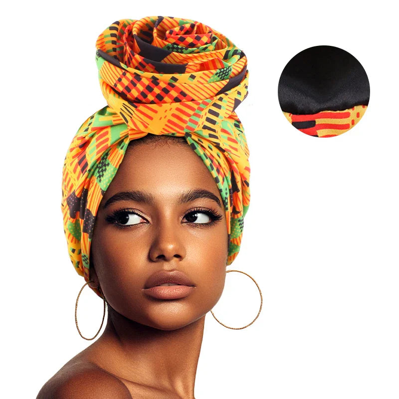 Bright orange and green Afrocentric Melody Headwrap with satin lining. Pre-tied floral design provides effortless elegance and hair protection.