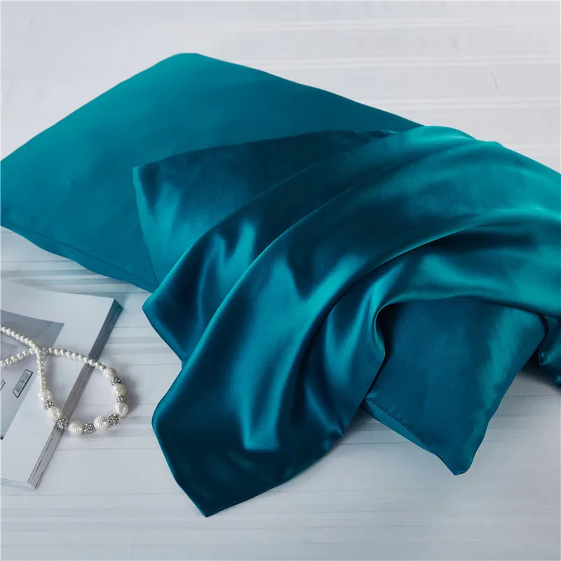 Deep teal natural mulberry silk pillowcase for locs. Smooth, breathable, and hypoallergenic for a luxurious and protective sleep experience.
