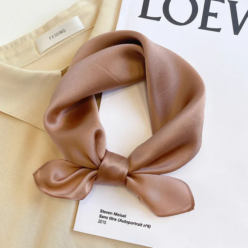 Silk Bandana Scarf - Ivory Elegant displayed on a cream blouse and fashion magazine, showcasing its smooth 100% silk texture and timeless hue.