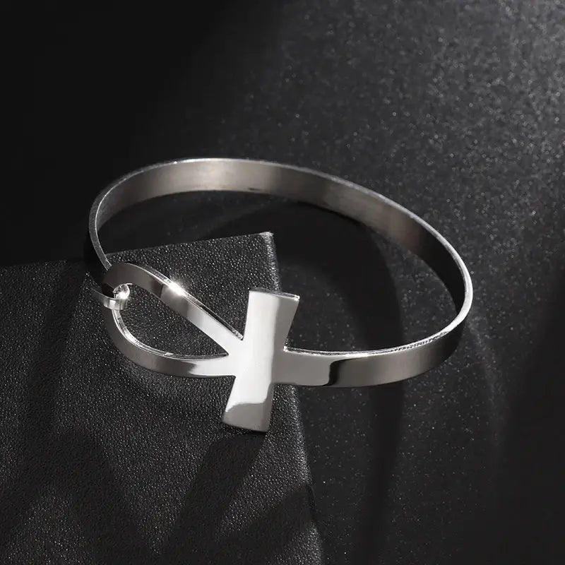 Silver-tone Faithful Embrace Hair Cuff and Bracelet with an Ankh design. Perfect for styling locs or wearing as a sleek, modern bracelet.