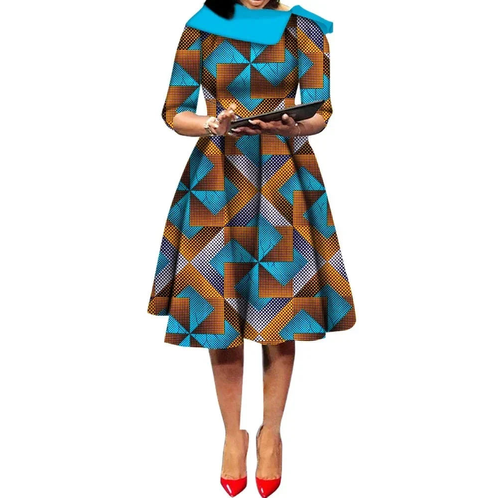 African Ankara Wax Print Midi Dress with geometric blue and brown patterns, featuring three-quarter sleeves and a flared skirt.