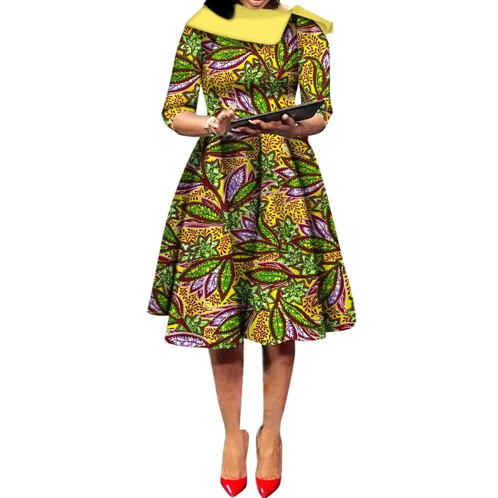 African Ankara Wax Print Midi Dress in yellow with multicolored leaf patterns, featuring a fitted bodice and flared skirt.
