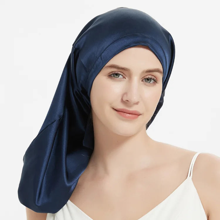 Navy Mulberry Silk Sleep Bonnet for long hair, modeled by woman. Frizz-free silk headwrap with adjustable fit for overnight use.