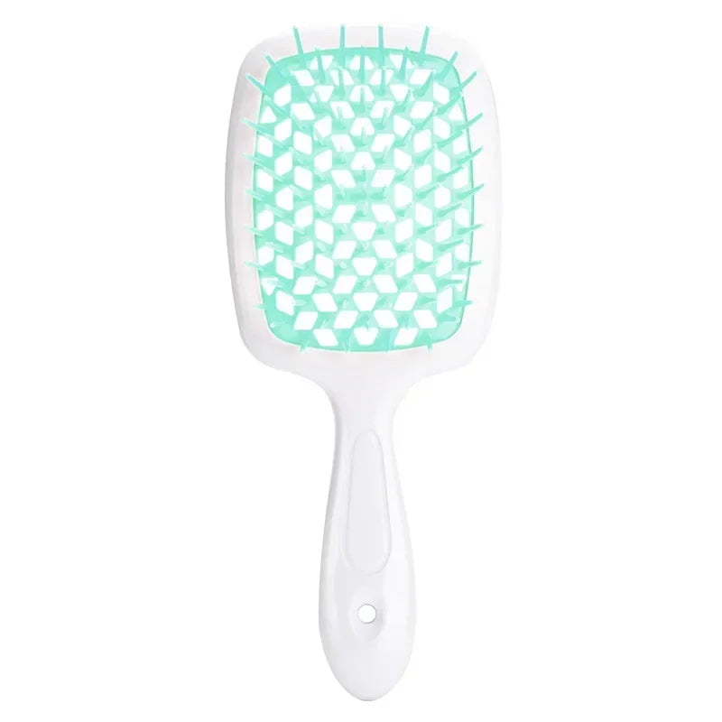 Green detangling brush with a honeycomb bristle structure for curly hair. Provides a comfortable grip and smooth detangling experience.