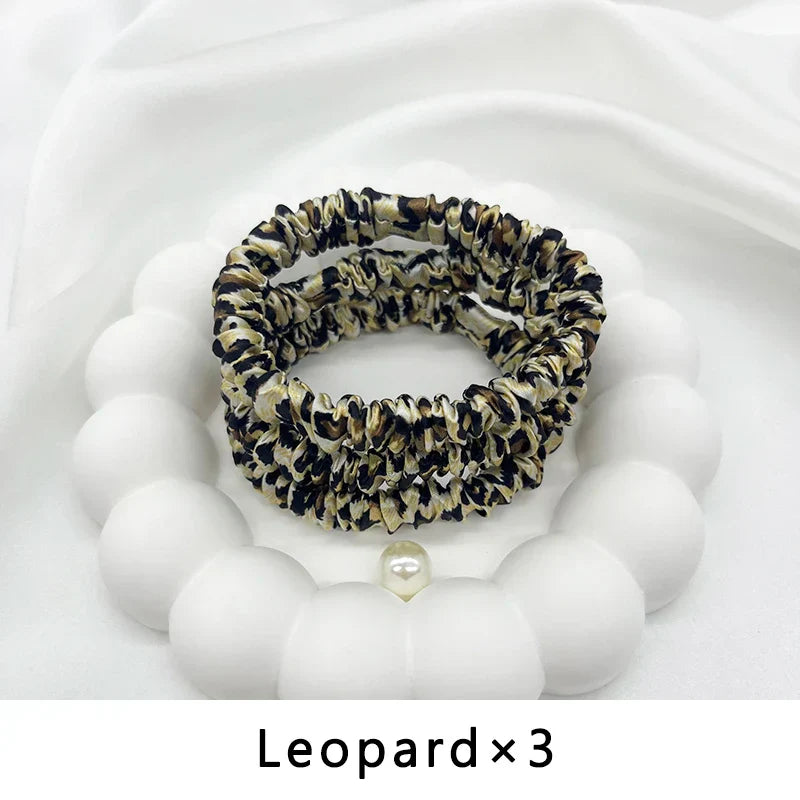 Three leopard print mulberry silk elastic hair bands. Stylish, frizz-free ponytail holders for natural hair and locs.