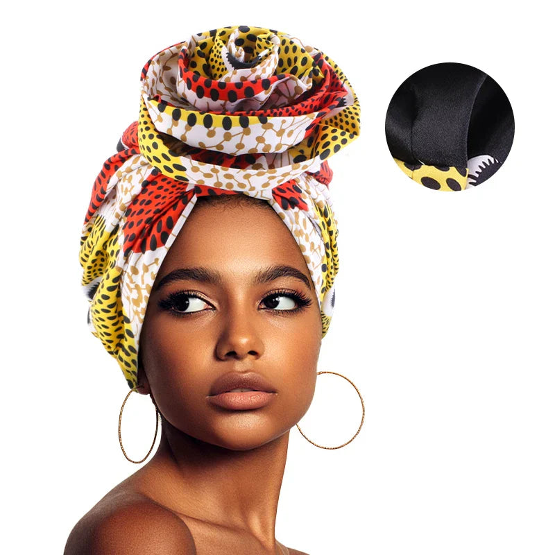 Yellow and red Afrocentric Melody Headwrap with satin lining, featuring a stylish African print. Perfect for protecting hair while adding a fashionable touch.