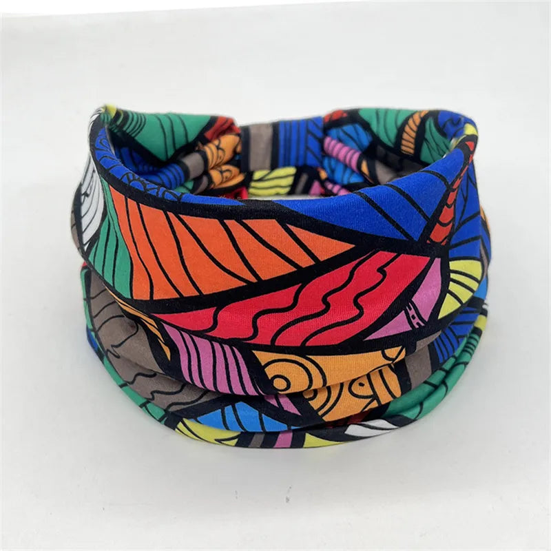 Colorful patterned yoga headband designed for braids, locs, sisterlocks, and dreadlocks. Soft, stretchy fabric for a secure and stylish fit.