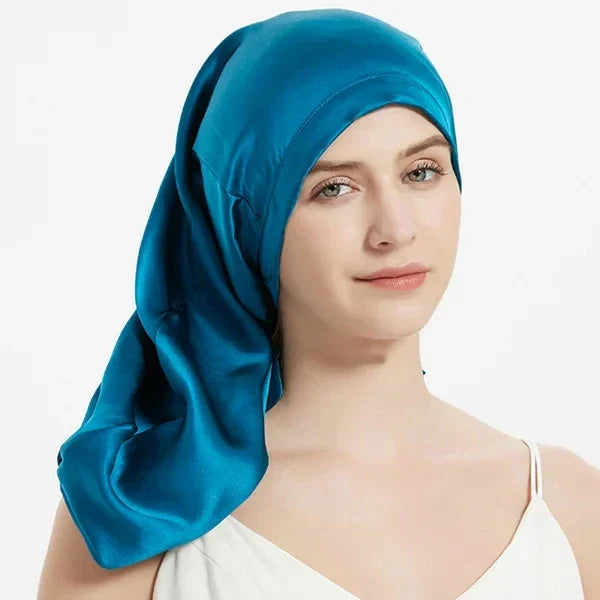 Teal Mulberry Silk Sleep Bonnet for long hair, worn by woman. Smooth silk headwrap ideal for braids, dreadlocks, and frizz-free sleep.