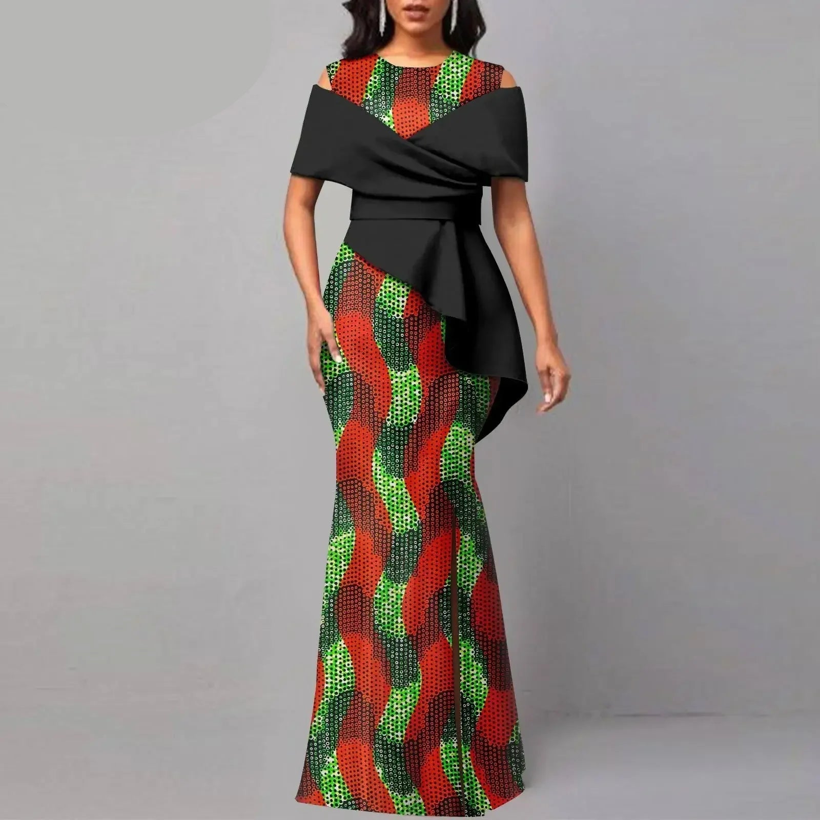 Woman wearing a colorful dress with black overlay, branded &