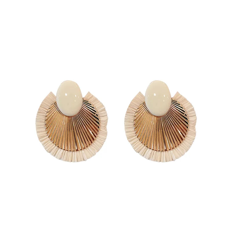 Ivory and gold fan tassel earrings on a white background, showcasing their intricate details and trendy, lightweight design.