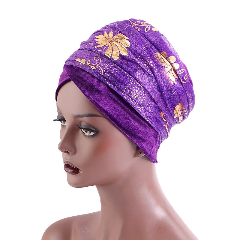 Purple Regal Amethyst Adorned Headwrap with gold floral accents, elegantly styled on a mannequin. A luxurious and fashionable headwrap for women.