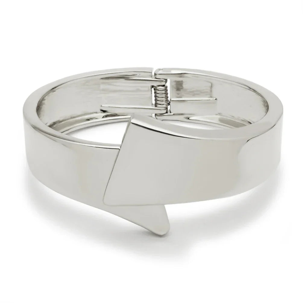 Silver-toned cuff bracelet with a geometric arrow design. A stylish and elegant accessory for special occasions.