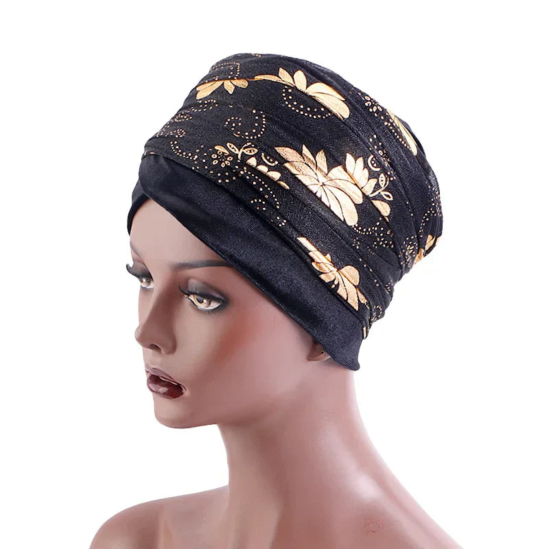 Black Regal Amethyst Adorned Headwrap with gold floral accents, displayed on a mannequin. A stylish and versatile headwrap for women.