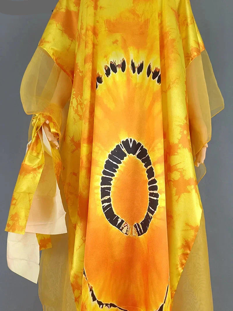 Close-up of yellow mesh patchwork caftan abaya dress, highlighting the intricate African print and delicate chiffon details.