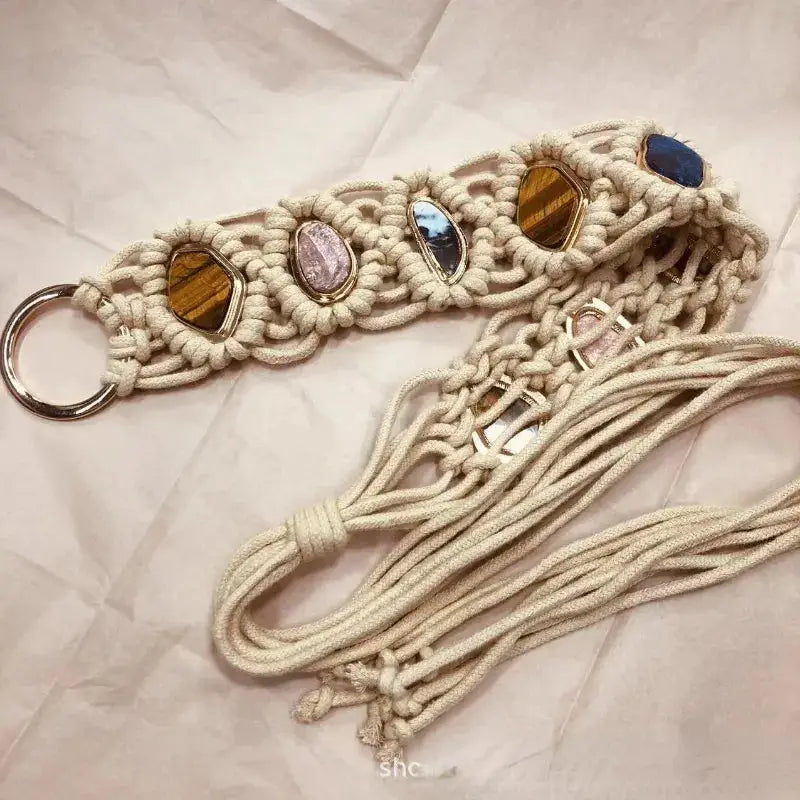 Handmade braided style woven tassel belt with intricate macramé design and colorful gemstone accents. Features a metal ring buckle and long tassel ties.