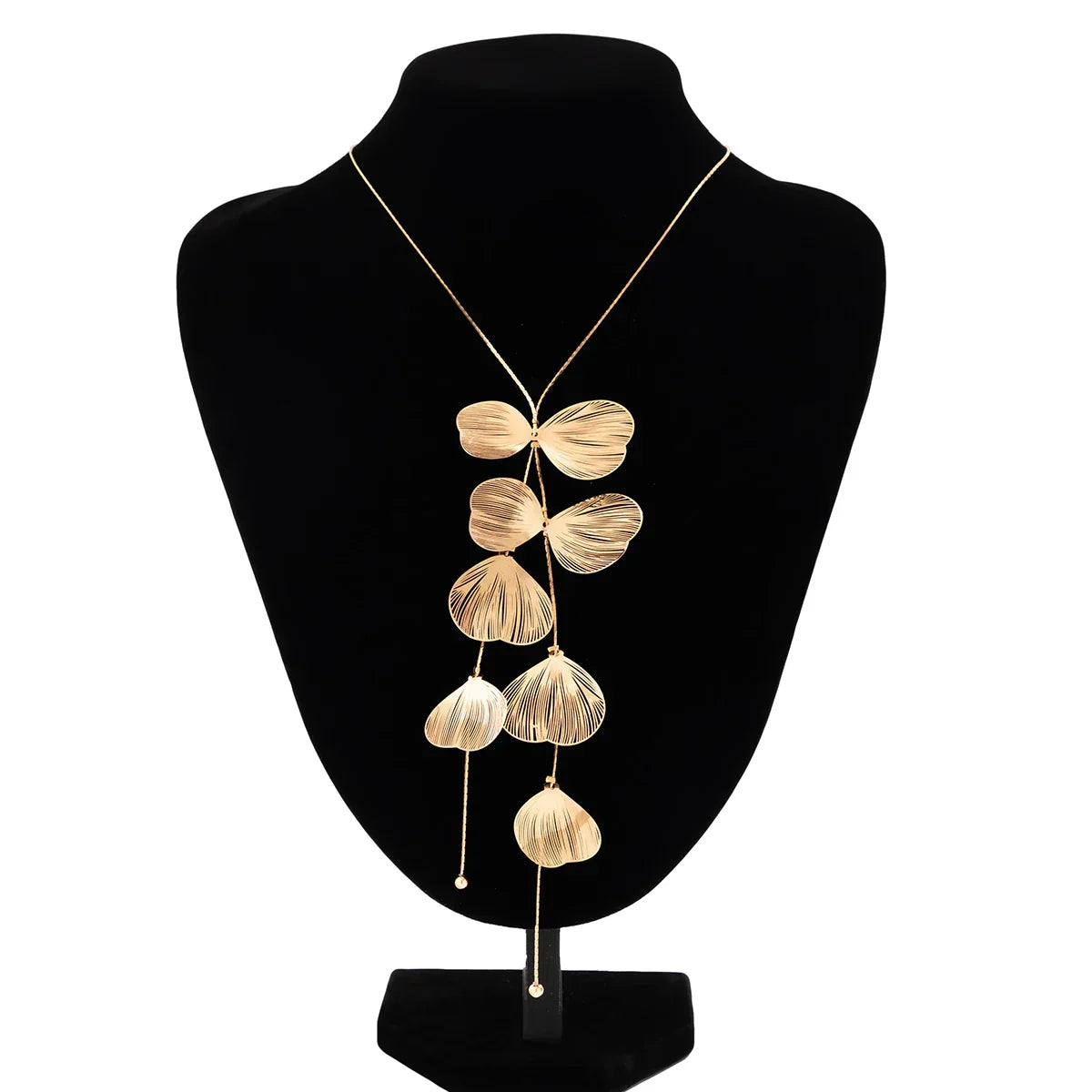 Gold petal tassel necklace choker displayed on a black bust stand, highlighting its intricate floral charm details and elegant cascading design.