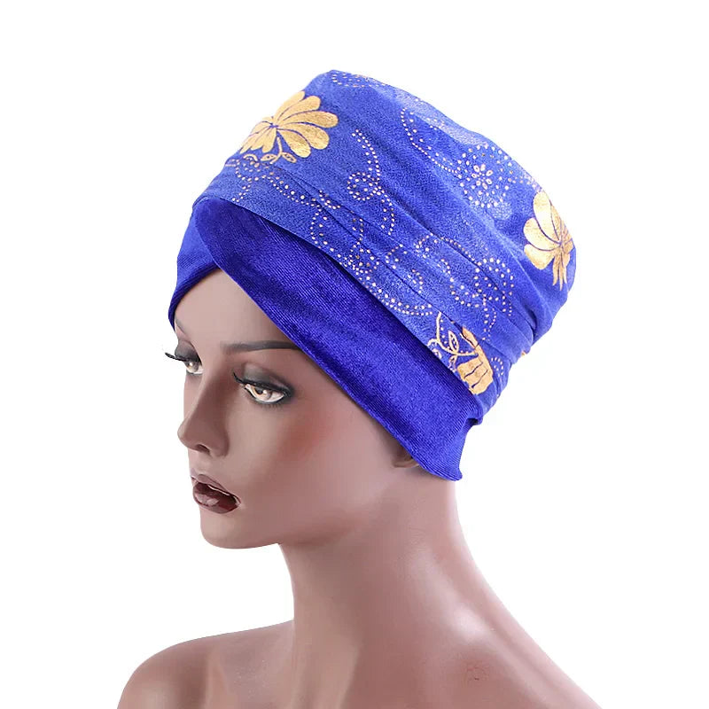 Blue Regal Amethyst Adorned Headwrap with gold floral patterns, displayed on a mannequin. A bold and elegant headwear choice for women.