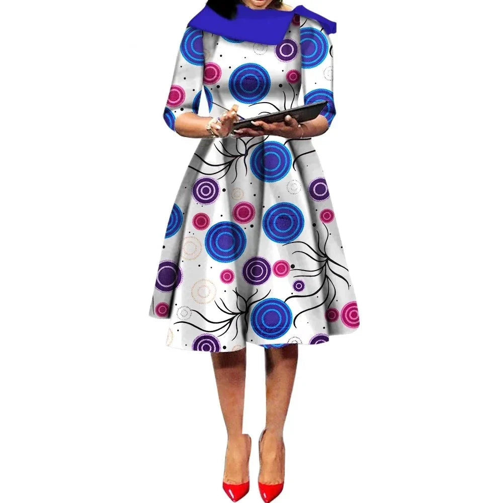 African Ankara Wax Print Midi Dress with a white base and blue and purple circular patterns, offering a modern look.