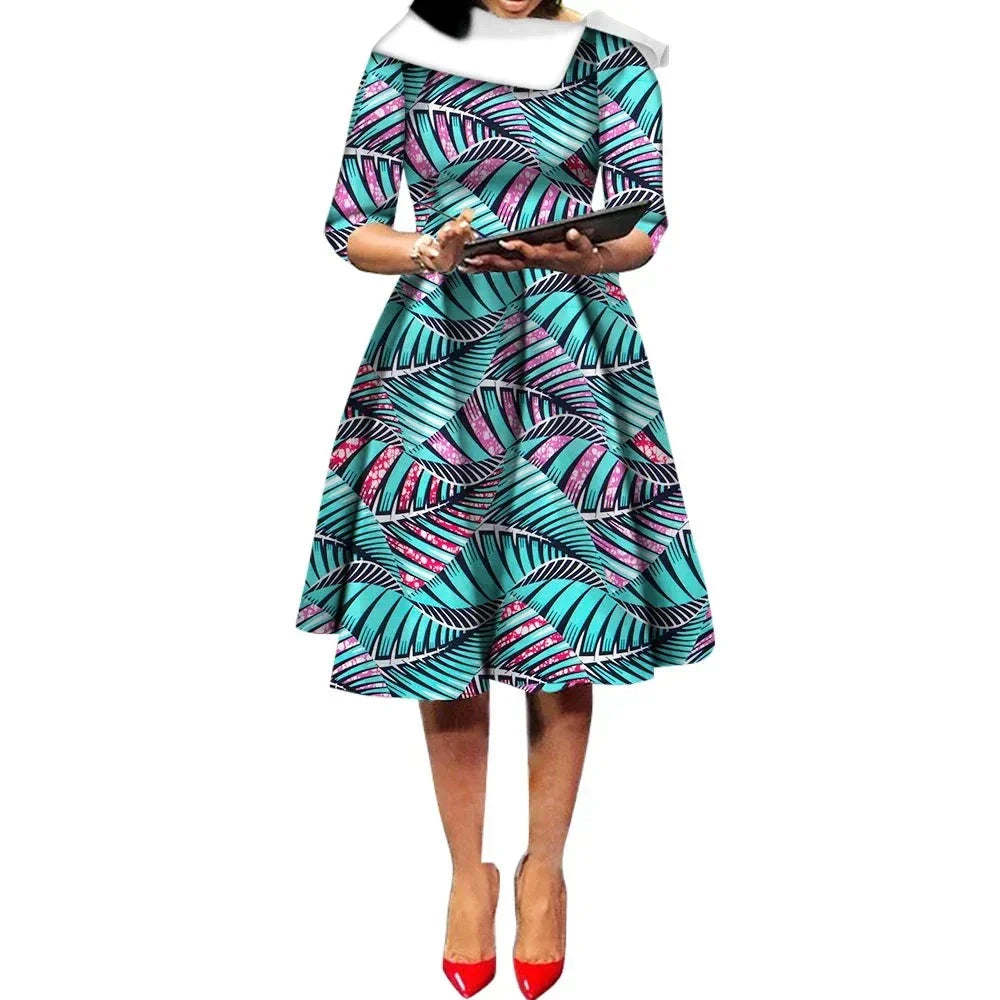 African Ankara Wax Print Midi Dress with turquoise and pink leaf patterns, three-quarter sleeves, and a flared silhouette.