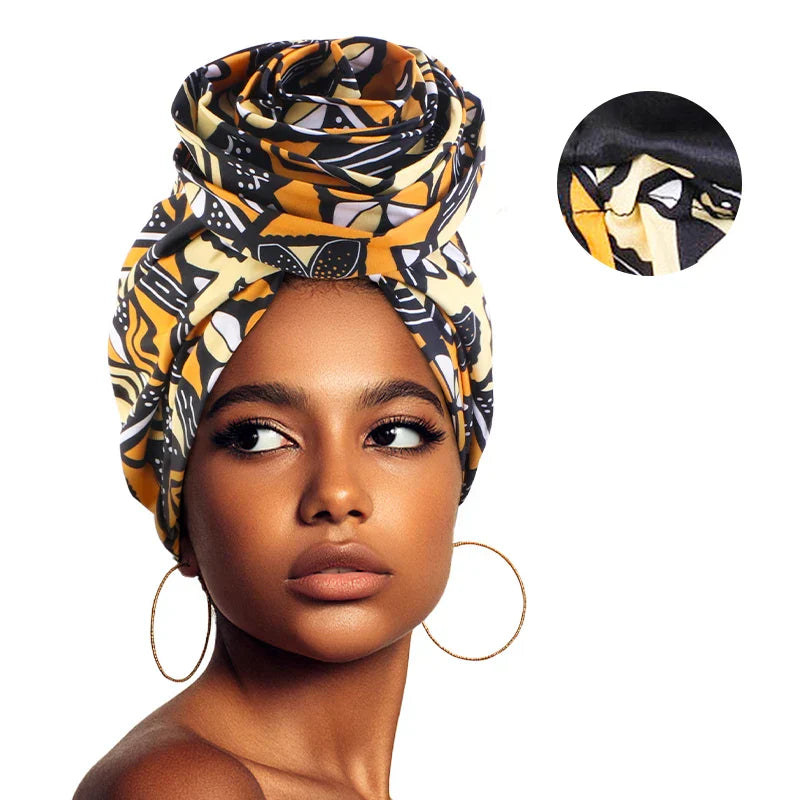 Yellow and black Afrocentric Melody Headwrap with satin lining, offering a striking African print. Designed for comfort, style, and hair protection.