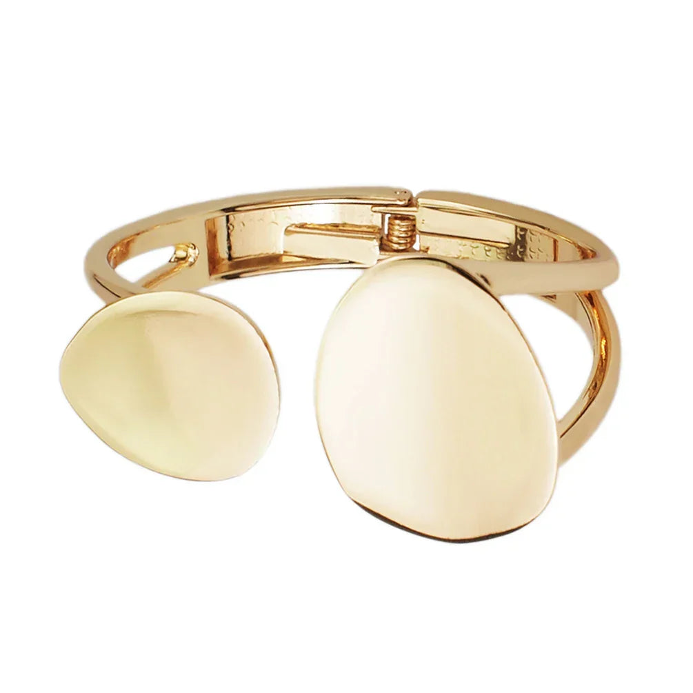 Gold open cuff bracelet with a minimalist, organic shape. A stylish and elegant accessory for special occasions.