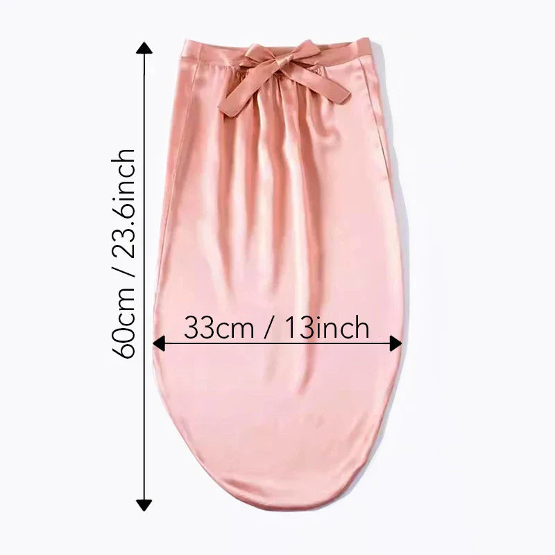 Flat lay of pink Mulberry Silk Sleep Bonnet with dimensions 60cm x 33cm. Adjustable headwrap for long hair, braids, and dreadlocks.